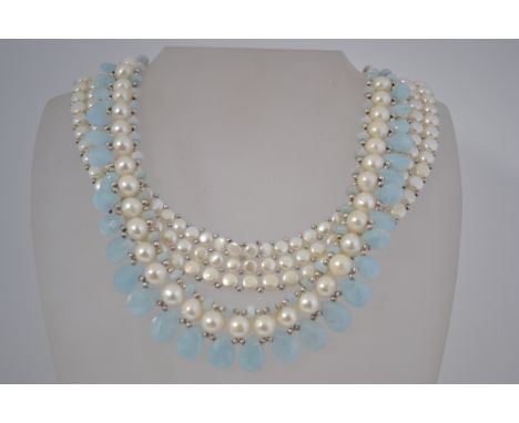 2 cultured pearl necklaces , one being arranged with milky aquamarine stones and the other being tri form . Both have silver 