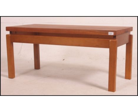 A vintage 1970's retro teak coffee table on ' floating ' wooden base of square form with rectangular top above .  45cm high x