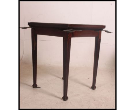 A vintage early 20th century square gaming / poker table having a flip over top with a brown baize lining, each corner having