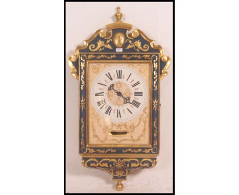A beautiful French blue and gilt wall clock with roman numeral chapter ring, faceted hands. All in the Rococo style with fini