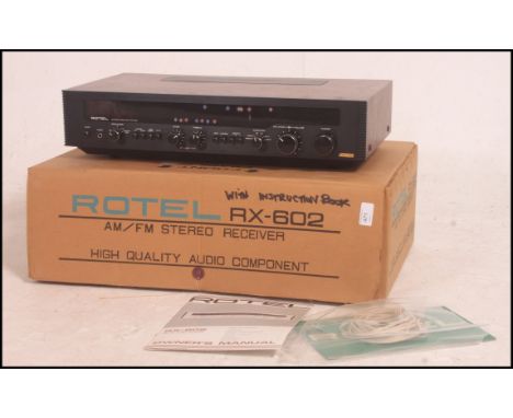 A 1970's vintage Rotel RX602 AM/FM stereo receiver being boxed complete with instructions.