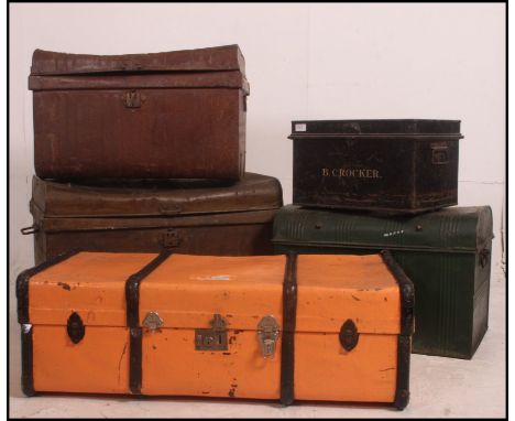 A good stack of vintage tack / steamer trunks along with a tin deed box and a canvas and wooden bound steamer trunk  .