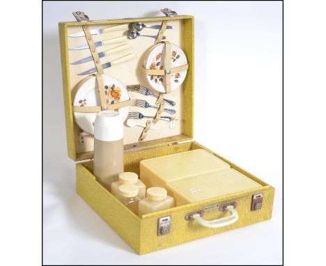 A vintage mid century retro yellow Brexton picnic hamper complete with the contents to include ceramics and tupperware. W40cm