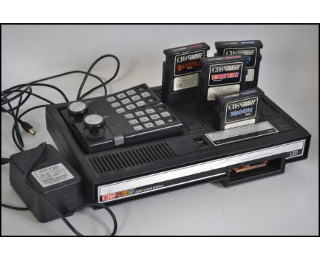 A vintage games console; Coleco Vision system, with a quantity of game cartridges to include Donkey Kong, Smurf etc. 