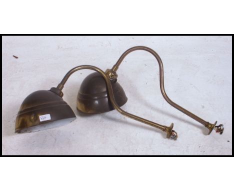 A pair of vintage early 20th century brass swan neck wall / sign lights having brass directional pendant shades. Measures: 36