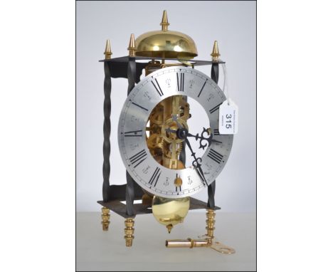 FRANZ HERMLE brass skeleton mantle clock, the spring driven movement striking on the top bell, with 5" (12.7cm) silvered roma