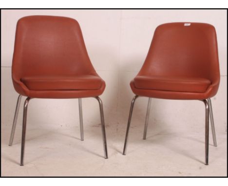 A pair of 1960's vintage / retro Ben type dining chairs having the original burgandy vinyl upholstered seats being raised on 