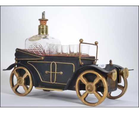 A vintage novelty musical decanter and glass set in the form of a motor car L35cm