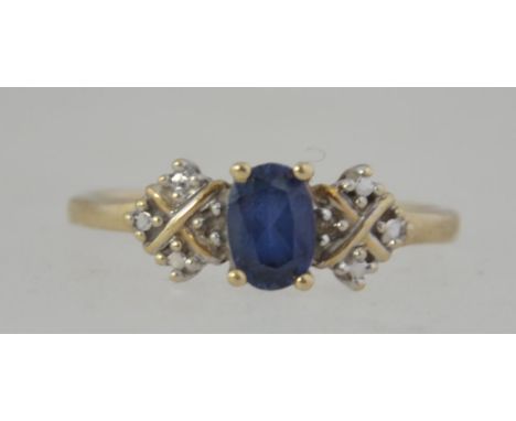 A vintage 10ct gold and sapphire ring. Illusion set shoulders with central oval cut sapphire approx 33pnts