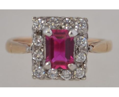 A 9ct gold and ruby garnet stone ladies dress ring, the central ruby garnet surrounded by clear cz stones. Size M / Weight 3.