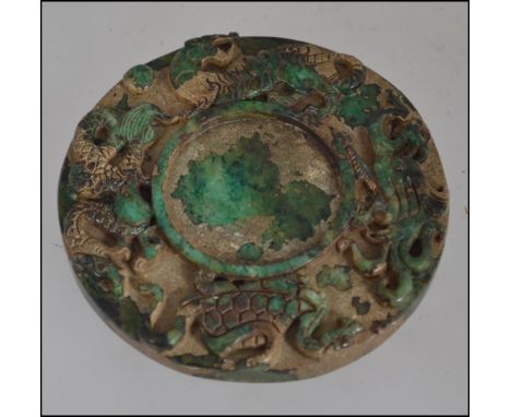 A large Oriental carved jade carved bi depicting dragons and other mythical beasts W8cm