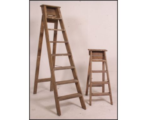 A vintage wooden eight rung step ladder along with a near matching smaller four rung wooden step ladder 195cm high.