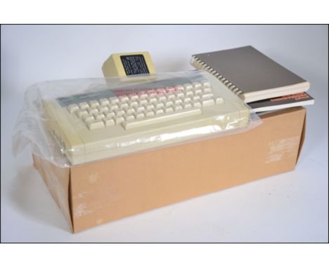 A vintage boxed Acorn computer system dating to the 1980's complete in the box with magazines of the period etc