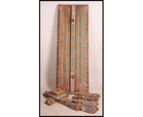 A collection of Indian painted embellishments of wooden construction to include base, carved detailed shelf mounted and a lar