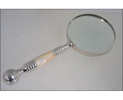 A hand held magnifying glass with a mother of pearl handle L25cm