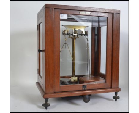 A SET OF CASED BALANCE SCALES, ' W and J George Ltd Birmingham 3, Nivoc, F E Becker & Co London EC1' label attached , plus bo