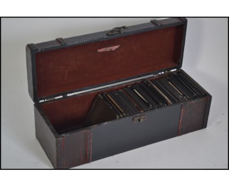 Vintage carry case with hook and eye fastener containing many monochromatic slides for a magic lantern, mostly featuring the 