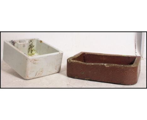 A vintage ceramic Belfast sink used as a garden planter along with another sink / garden planter. Measure: 15cms high x 61cms