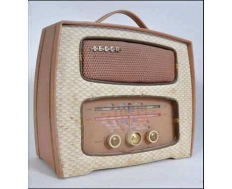 A vintage mid 20th century Decca TP 22 transistor radio, having speaker and display to front and finished in a soft salmon pi