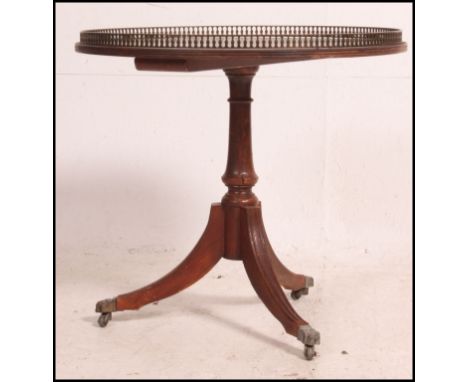 A good quality Regency style mahogany side / lamp / wine table raised on tripod base with tooled leather top having brass gal