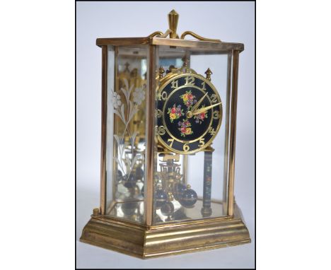 20th Century large German glass cased mantle clock , handpainted dial with floret patternation on a black background . H25cm