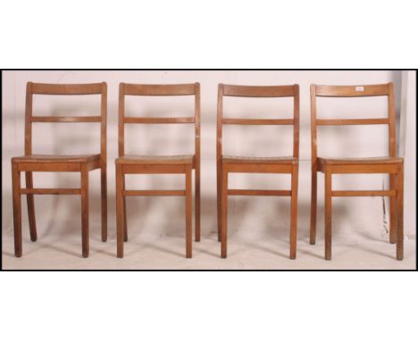 A set of 4 vintage slatted beechwood school - stacking hall chairs raised on squared legs united by stretchers 