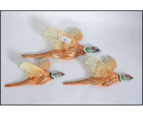 A set of three vintage graduating wall hanging Pheasants, each having a Beswick stamp to reverse Largest L31cm