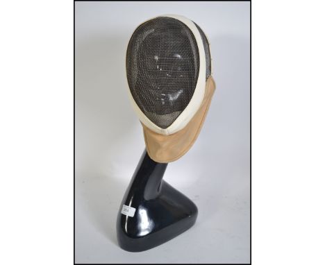 A vintage fencing mask by Leon Play together with an art deco style mannequin shop display dummy head H55cm