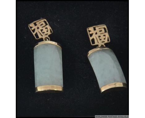 A pair of jade and 9ct gold drop earrings the earrings of oblong form with sleeper clasp fittings