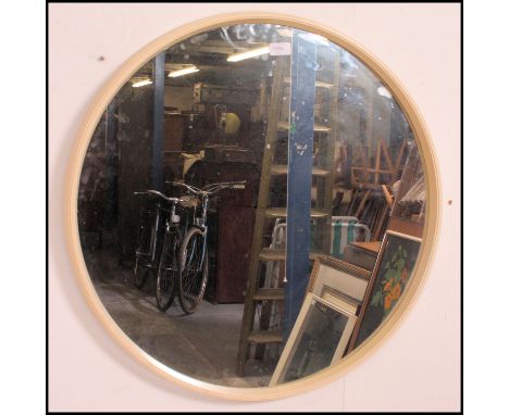 A 1950's large atomic style retro circular wall mirror set within original white resin surround. 68cm diameter.