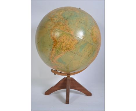 A retro desk globe. The parent Pupil Worldmaster Globe raised on a teak base. H48cm