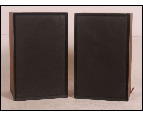 A pair of vintage / retro teak cased speakers with fabric covers and wall brackets attached