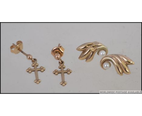 A pair of 375 - 9ct gold earrings in the form of crosses / crucifix together with a pair of 9ct gold and seed pearl ladies ea