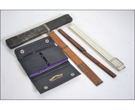 A collection of vintage 20th century rules and measures to include Prestons & Sons, Guinness, A West etc. Also a good cased m