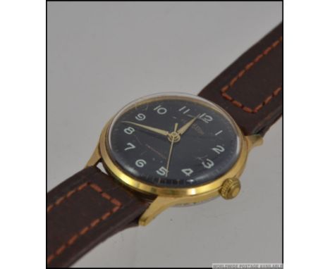 A good Gladiator vintage black faced gentlemans wristwatch having luminous baton numerals with faceted luminous hands set to 