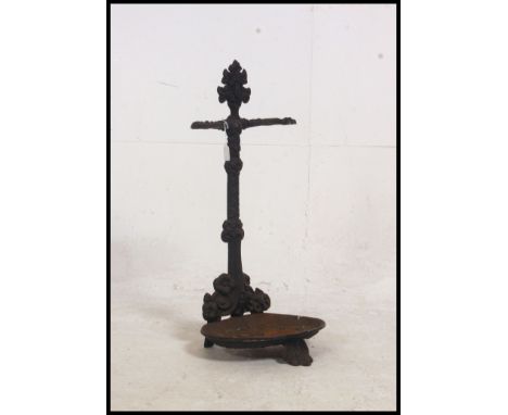 A  Coalbrookdale style umbrella stand in cast iron with painted black  finish, scallop tray to base with foliate and floral u