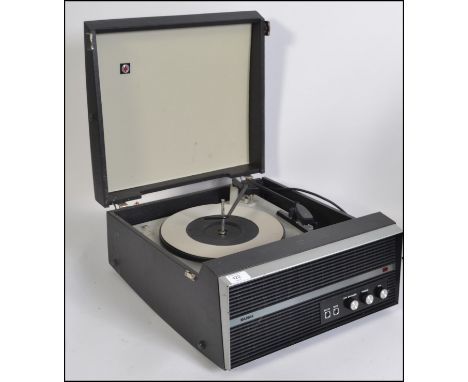 A vintage Bush mid century portable record player set within vinyl case having hinged top with inset deck and decorative faci