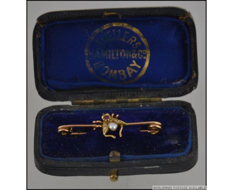 A Victorian 9ct gold ruby and baroque pearl bug - fly brooch pin. The fly with seed pearl wings with baroque pearl and ruby a