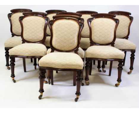 A set of eight Victorian mahogany dining chairs, each having recently reupholstered waisted backs and stuff-over seats, raise