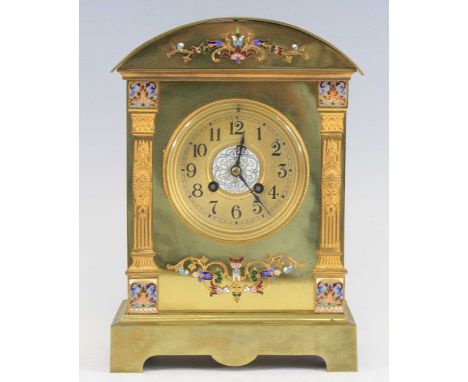 A late 19th century French gilt brass and champleve enamel mantel clock, the circular Arabic dial having twin winding holes f