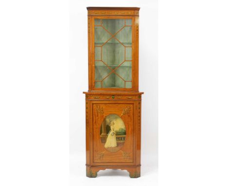 A Sheraton Revival painted satinwood freestanding corner cabinet, having glazed upper section, the base with cupboard door pa