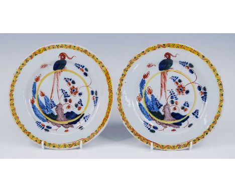 A pair of London polychrome delftware plates, probably Norfolk House, circa 1730, each decorated with a bird amongst flowers 