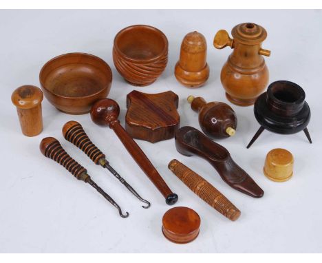 A small collection of 19th century and later treen wares to include an oak pocket snuff-box of shield shape, a box-wood light