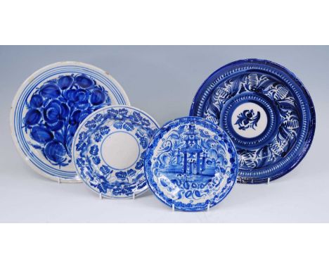 A Spanish Manises blue and white plate, 19th century, decorated with a pagoda, dia.22cm, together with three similar Spanish 