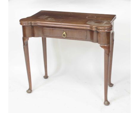 An early George III mahogany card table, the fold-over top with proud and dished corners, and opening to reveal baize lined p