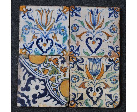 A matched set of three Dutch polychrome tiles, early 17th century, decorated with a tulip within a fleur-de-lis surround, 13.
