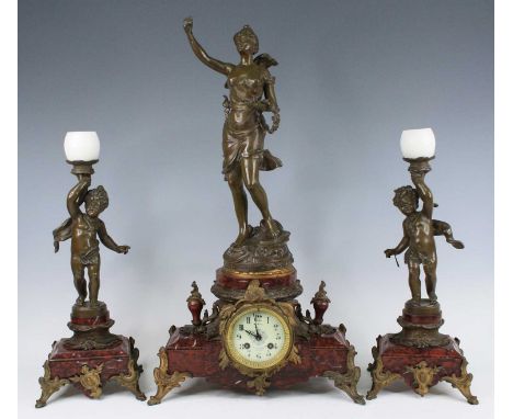 An early 20th century French bronzed metal and marble three-piece clock garniture, the indistinctly signed white enamel dial 