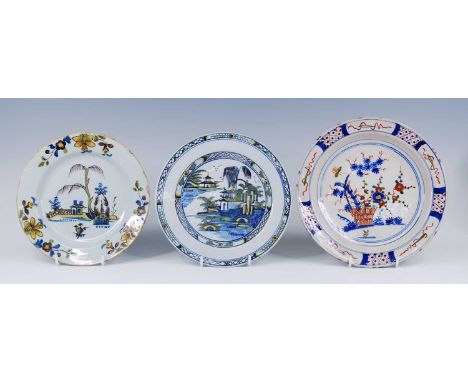 A Bristol polychrome delftware plate, possibly Limekiln Lane, circa 1740, decorated with flowers, dia.26cm, together with two