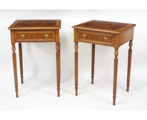 A pair of walnut and figured walnut single drawer lamp tables in the 19th century style, each having cross and feather banded
