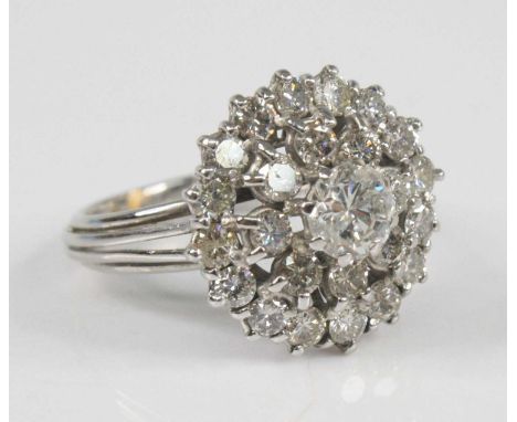 A white metal diamond circular cluster ring, featuring a centre round brilliant cut diamond within two double halo of eight a